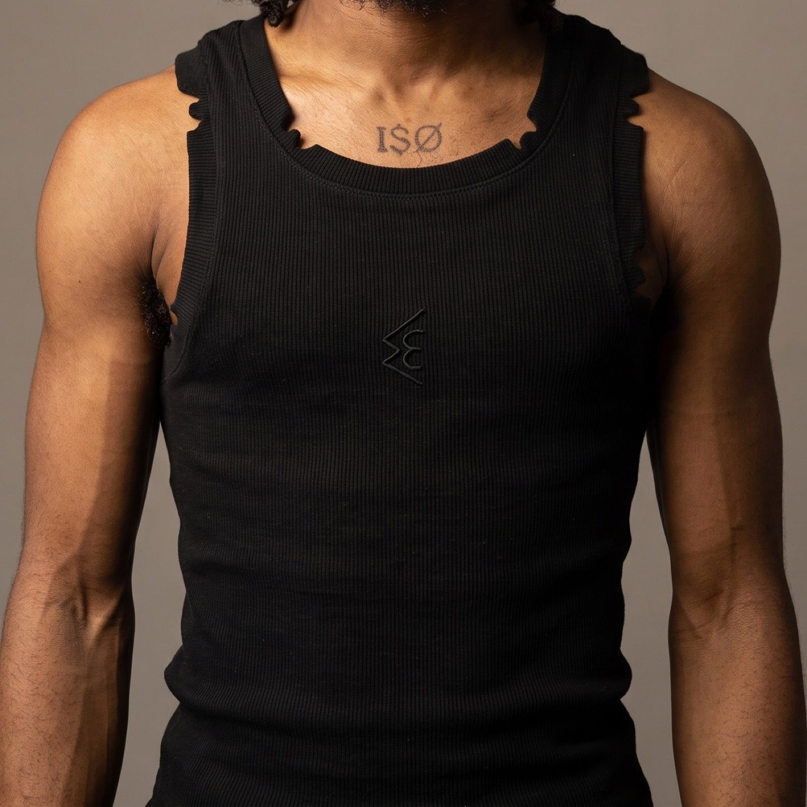 WATTS KEEN tank top in black, front view, showing the castellated hand-cut notches along the neckband and armholes