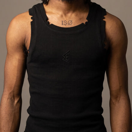 WATTS KEEN tank top in black, front view, showing the castellated hand-cut notches along the neckband and armholes