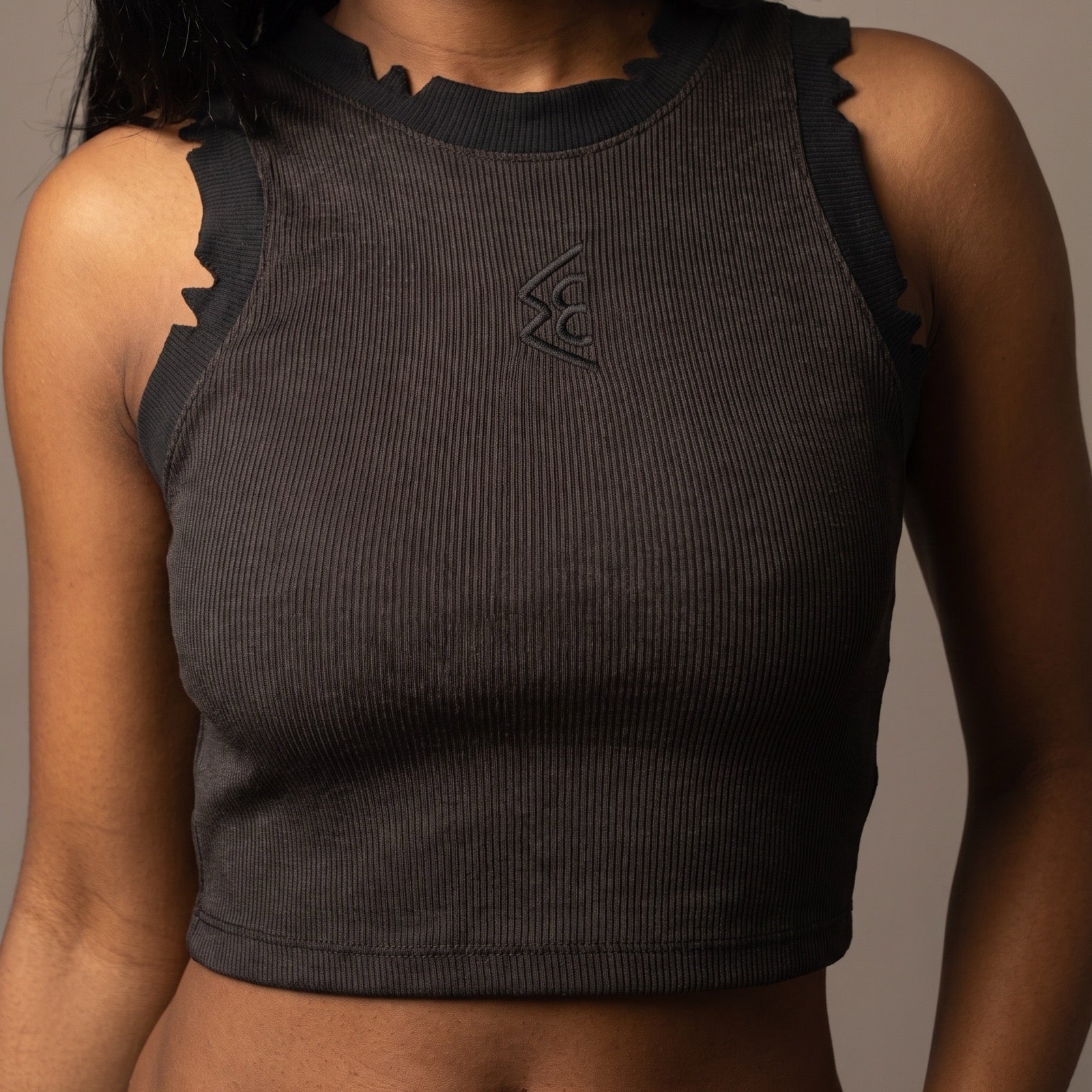 WATTS KEEN cropped tank in black, front view, showing the castellated hand-cut notches along the neckband and armholes